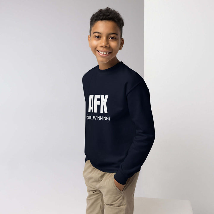 AFK youth crewneck sweatshirt modeled by smiling boy in navy blue, showcasing comfort and effortless style for kids.