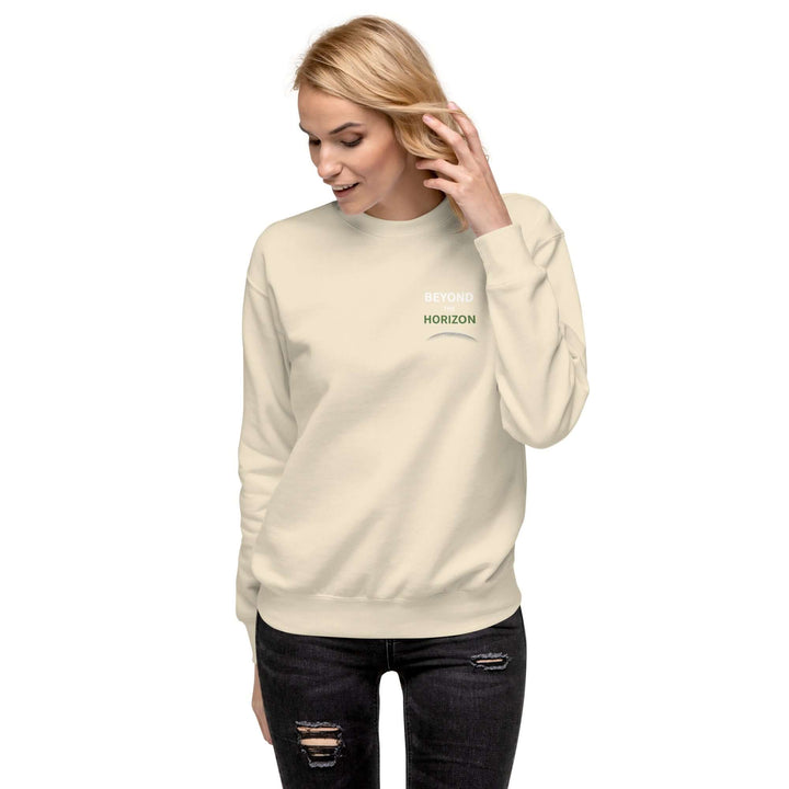 Model wearing Beyond the Horizon Unisex Premium Sweatshirt in cream, showcasing its comfort and stylish design.