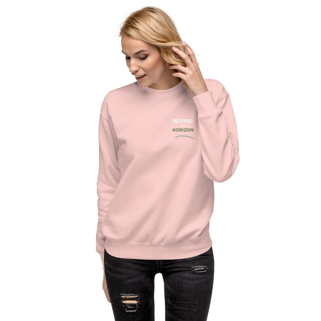 Beyond the Horizon Unisex Premium Sweatshirt in pink worn by a model, featuring ribbed neck and cuffs.