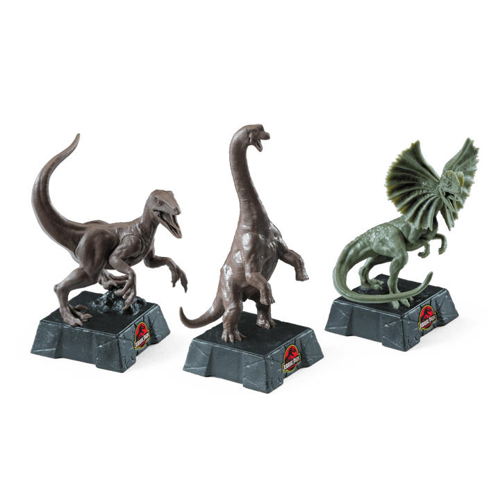 Jurassic Park Chess Set featuring detailed dinosaur pieces including Velociraptor, Brachiosaurus, and Dilophosaurus.