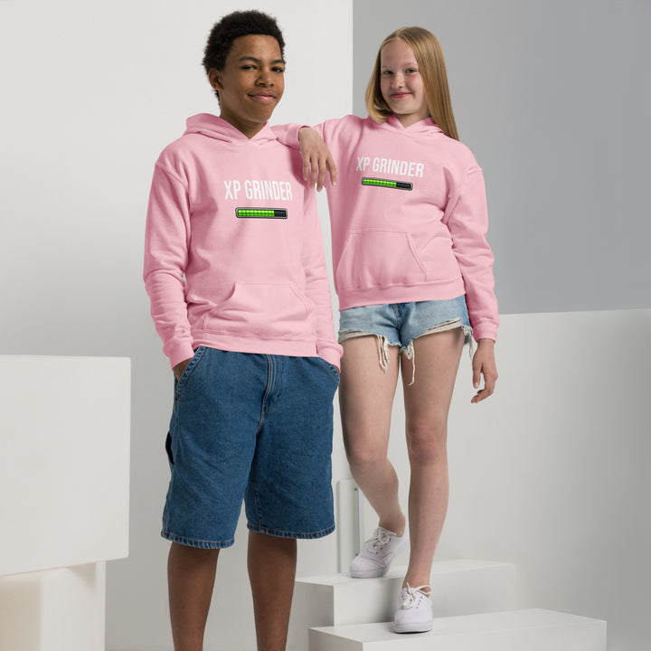 Two youth wearing XP Grinder Youth heavy blend hoodie in pink color, showcasing comfort and style.